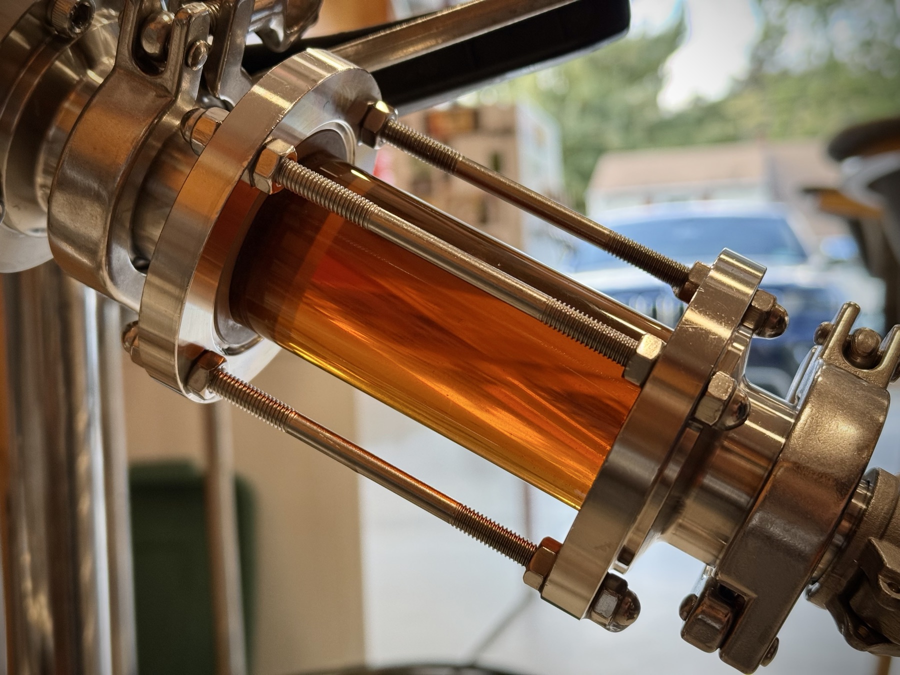 Bright beer flowing through a stainless sight glass